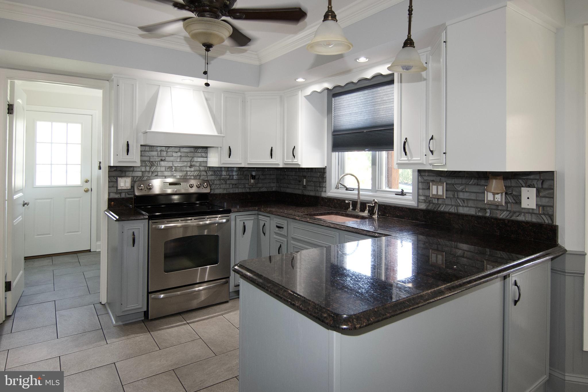 7451 Valley View Lane Reading, PA 19606 - Photo 17 of 61 a kitchen with stainless steel appliances granite countertop a sink a stove and cabinets