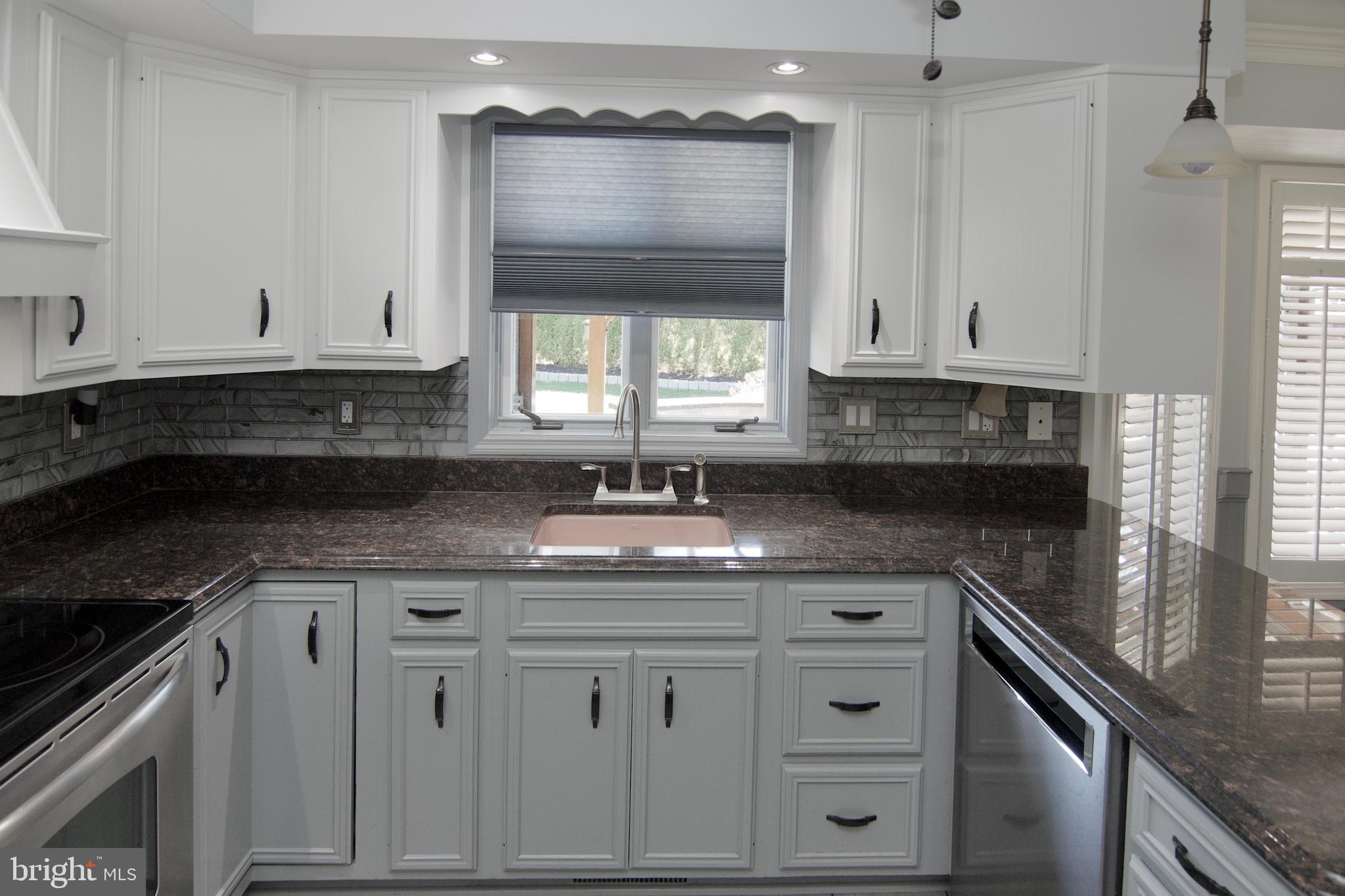 7451 Valley View Lane Reading, PA 19606 - Photo 19 of 61 a kitchen with granite countertop a sink window and cabinets
