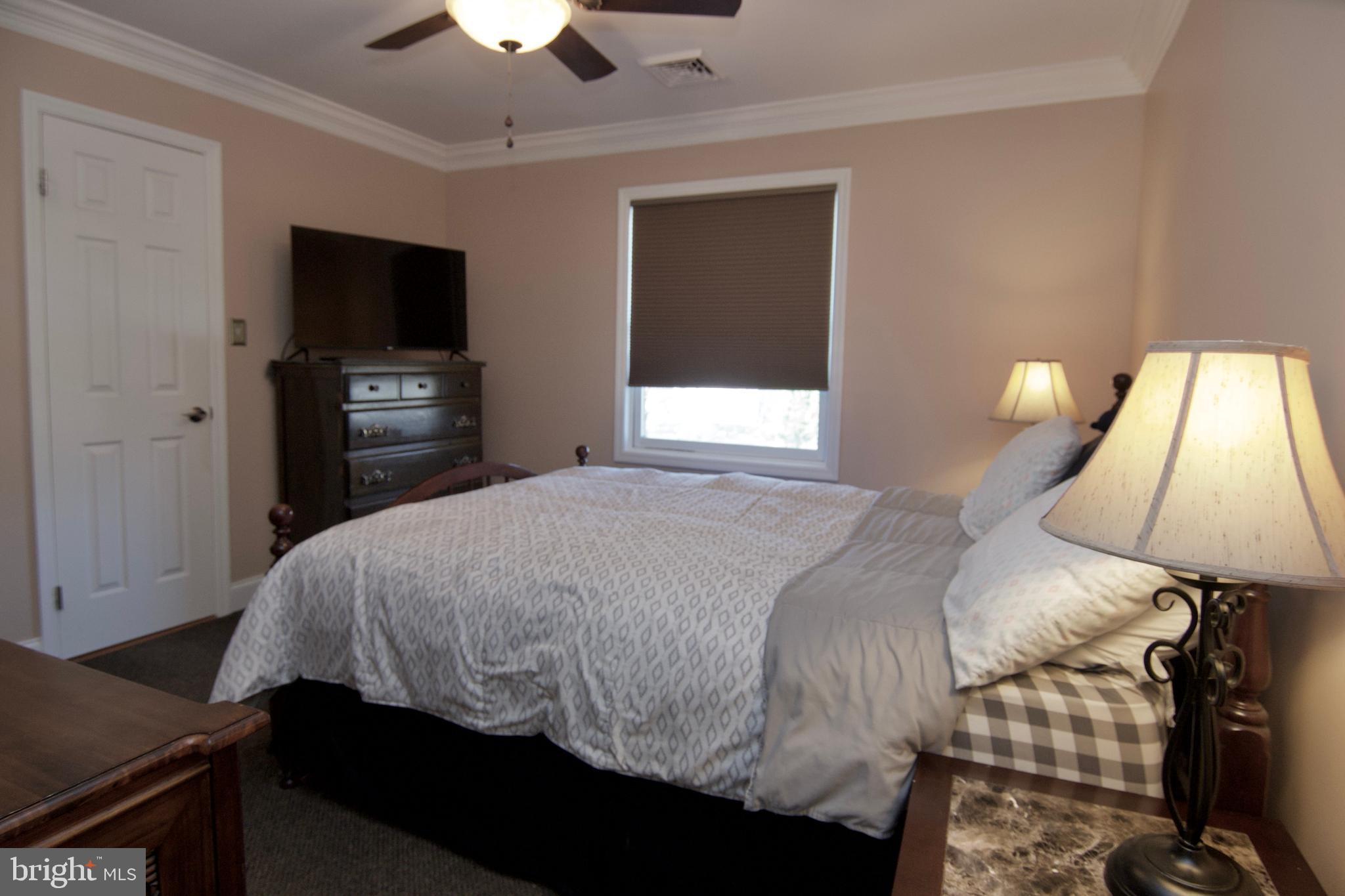7451 Valley View Lane Reading, PA 19606 - Photo 35 of 61 a bedroom with a bed and a flat tv screen on dresser