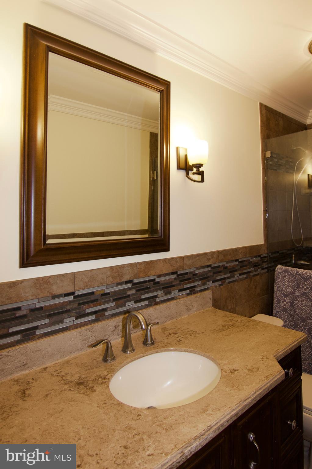 7451 Valley View Lane Reading, PA 19606 - Photo 38 of 61 a bathroom with a granite countertop sink and a mirror
