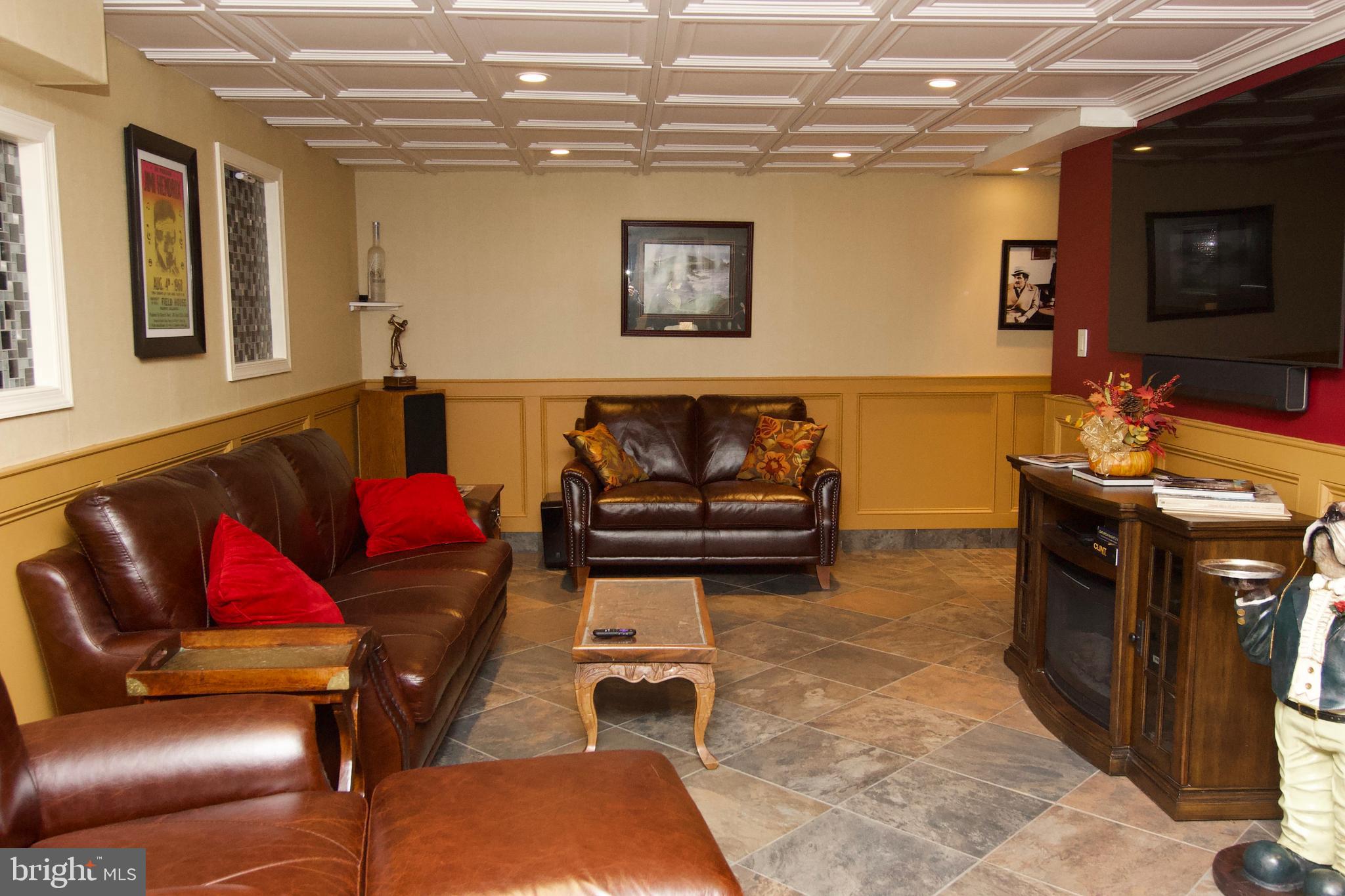 7451 Valley View Lane Reading, PA 19606 - Photo 40 of 61 a living room with furniture a flat screen tv and kitchen view