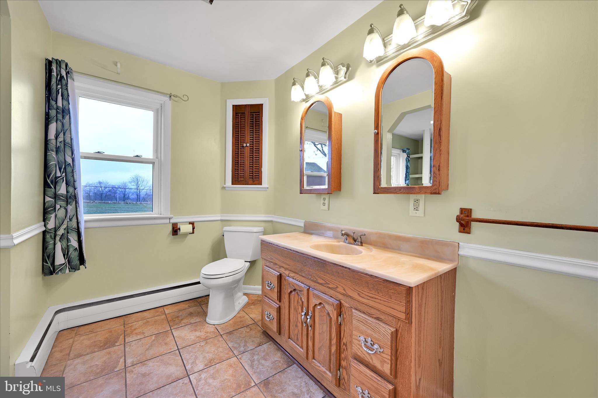 5030 Yorkana Road York, PA 17406 - Photo 17 of 31 a bathroom with a double vanity sink a toilet and a mirror