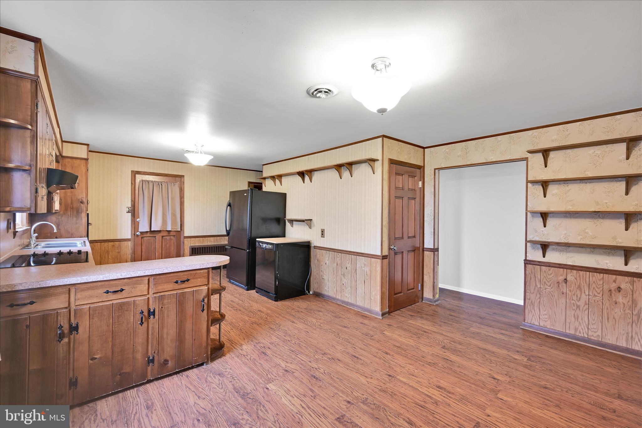 5030 Yorkana Road York, PA 17406 - Photo 9 of 31 a large white kitchen with wooden floors and stainless steel appliances