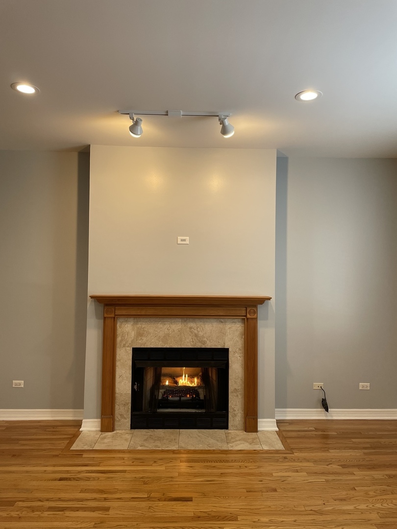 Undisclosed Address Chicago, IL 60642 - Photo 3 of 24 a living room with a fireplace