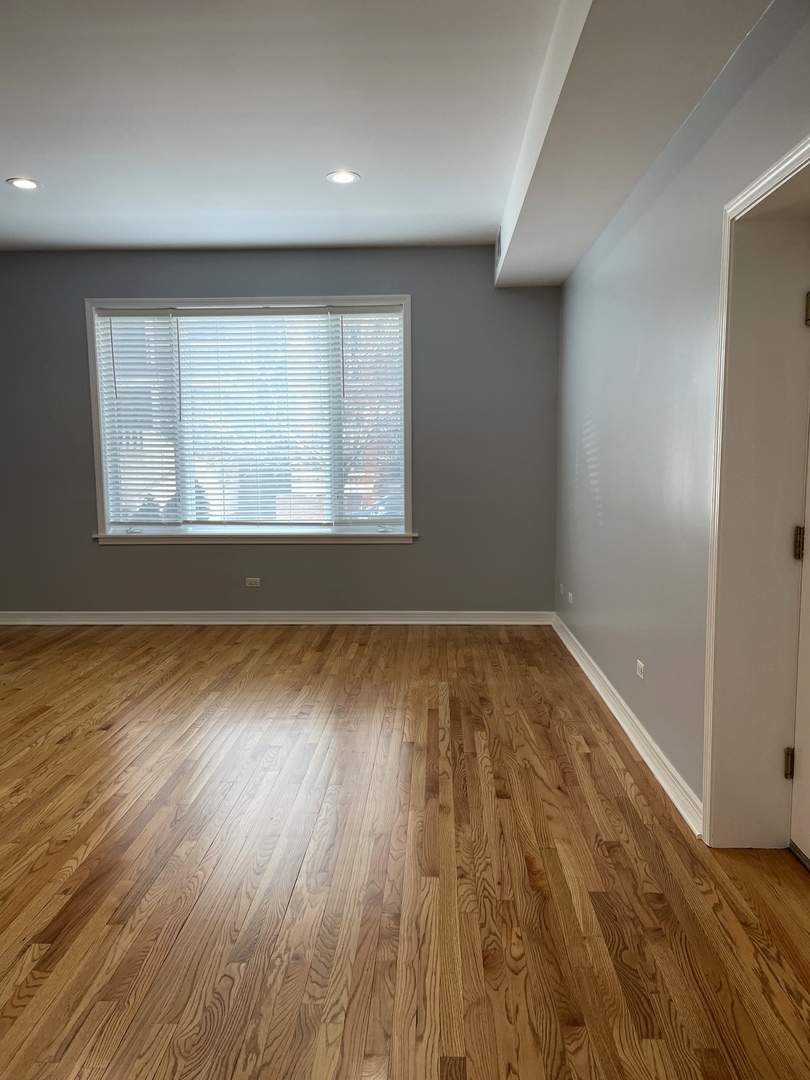 Undisclosed Address Chicago, IL 60642 - Photo 4 of 24 an empty room with wooden floor and windows