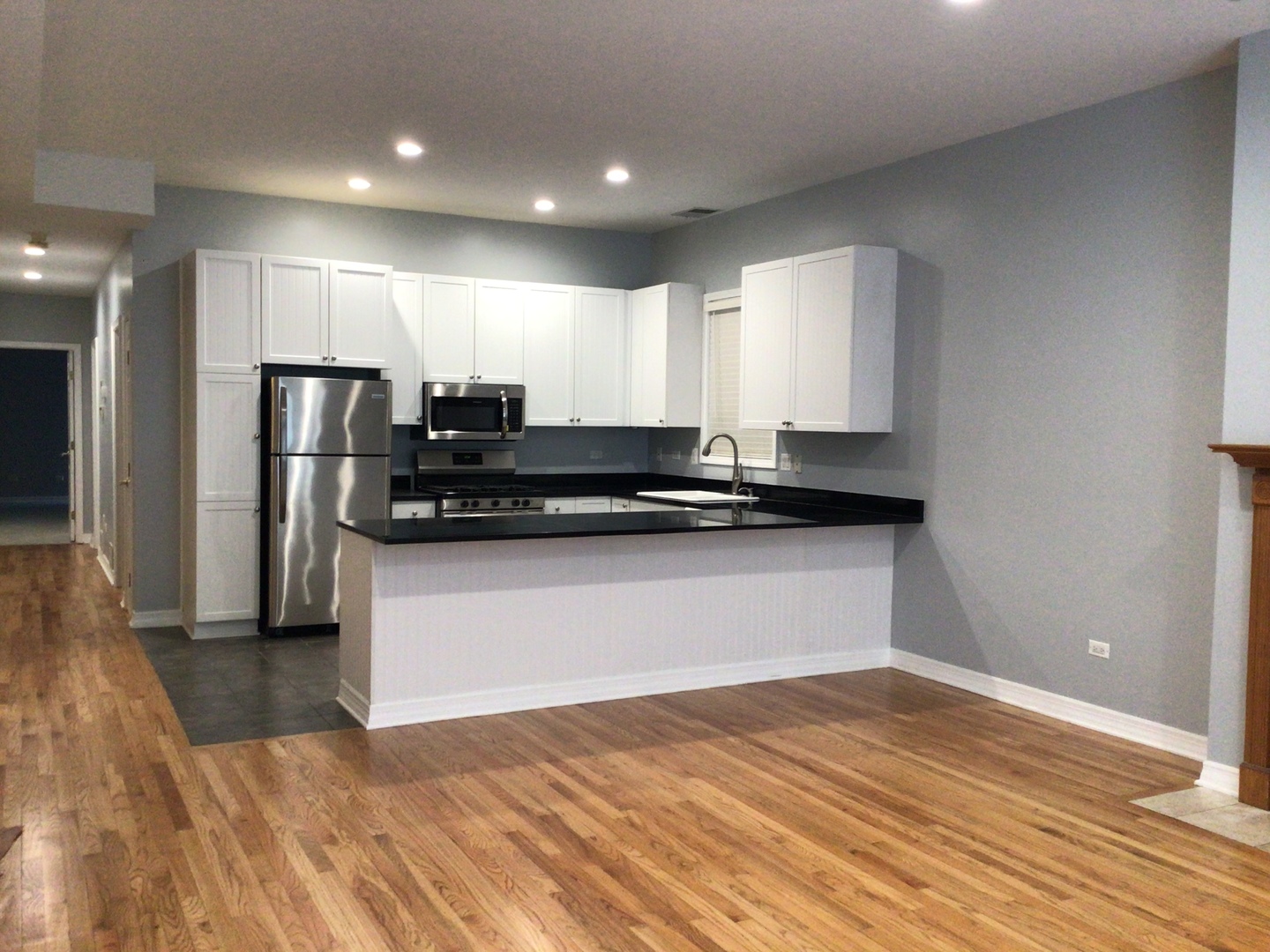 Undisclosed Address Chicago, IL 60642 - Photo 5 of 24 a view of kitchen with refrigerator stove and wooden floor