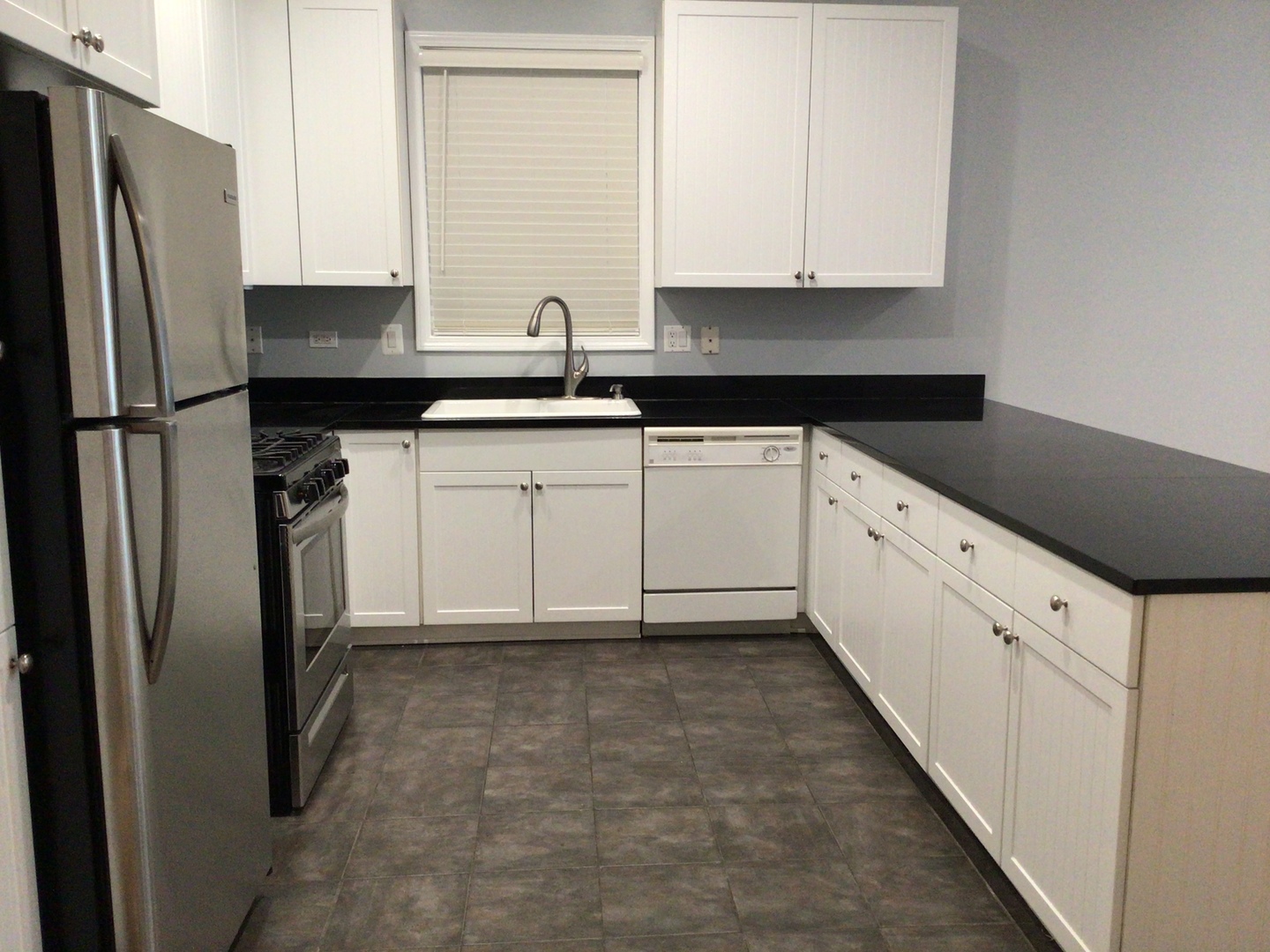 Undisclosed Address Chicago, IL 60642 - Photo 6 of 24 a kitchen with granite countertop a refrigerator sink and cabinets
