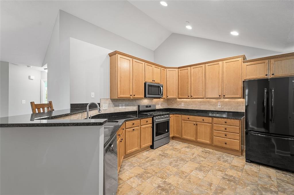 2002 Southview Drive Harmony, PA 16037 - Photo 23 of 47 a kitchen with stainless steel appliances granite countertop a stove a sink dishwasher a refrigerator and cabinets with wooden floor