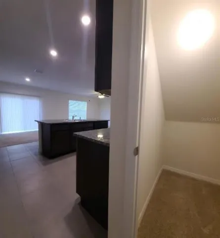 a view of an empty room with a fireplace