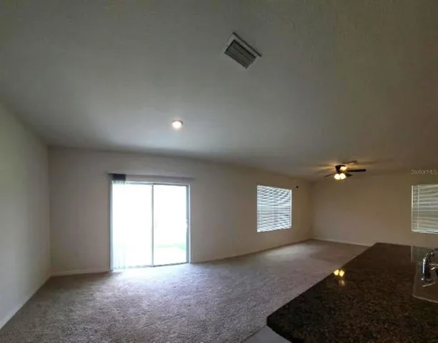 a view of an empty room and a window