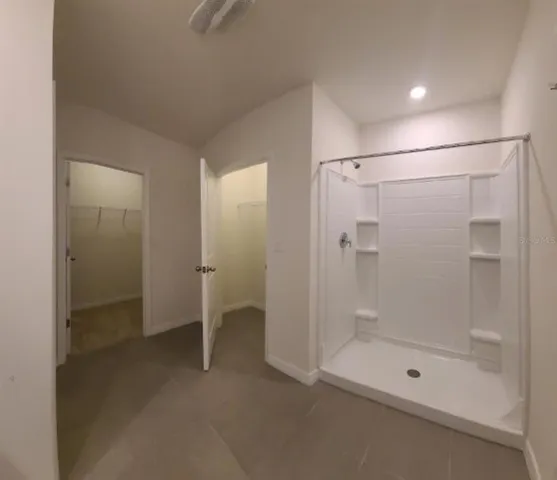 a bathroom with a glass shower door