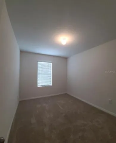 a view of an empty room with a closet