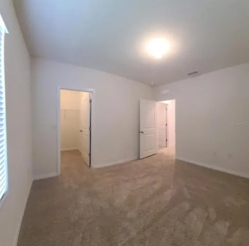 a view of an empty room and a window
