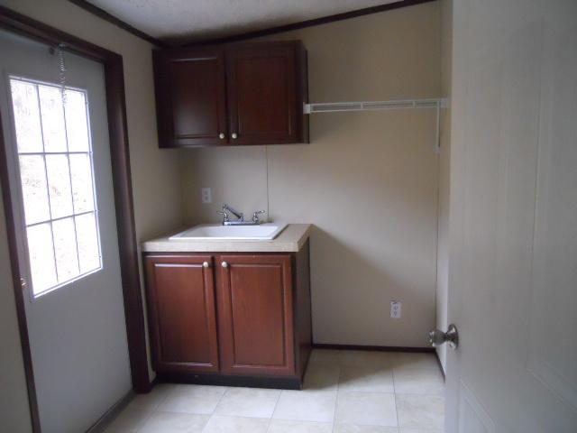 988 Coaling Road Charlotte, TN 37036 - Photo 3 of 19 LARGE UTILITY ROOM, BACK DOOR, WASH BOWL