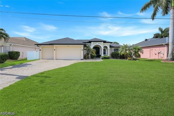 a front view of a house with a yard and garage