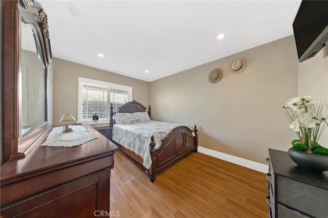 a bedroom with a bed and flat screen tv