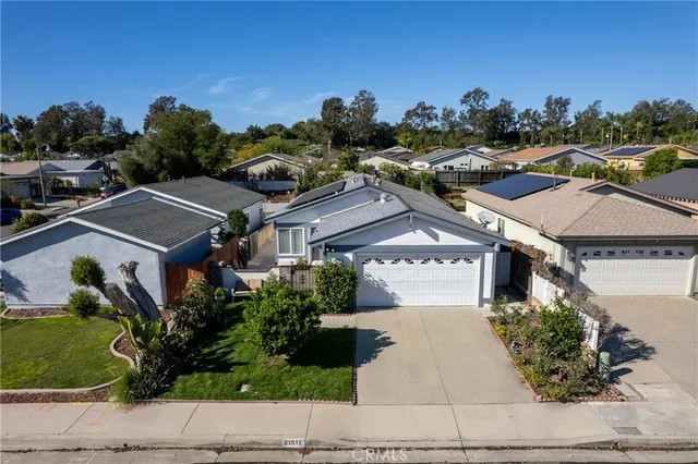an aerial view of multiple houses with a street