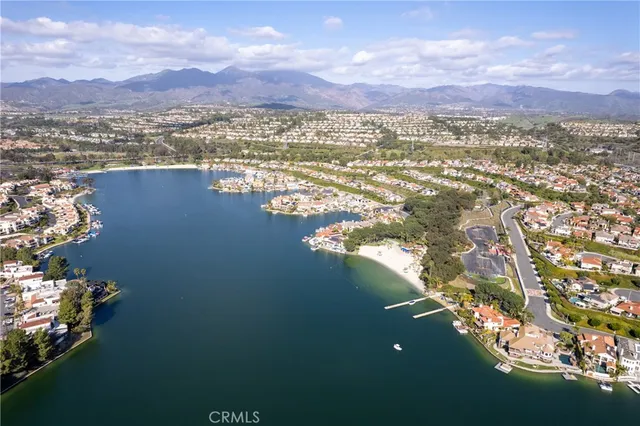 a view of a lake with boats and trees in the background