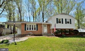 8303 Brixton Street Springfield, VA 22152 - Photo 1 of 5 a front view of a house with a yard