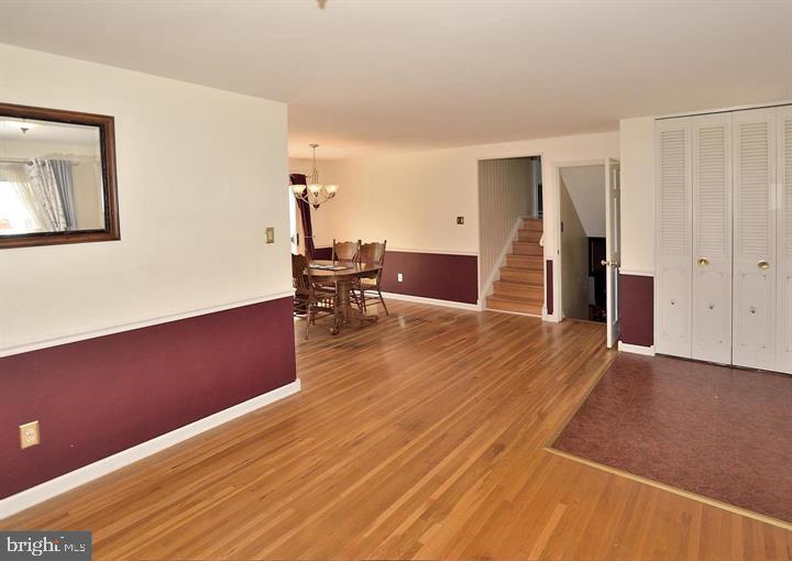 8303 Brixton Street Springfield, VA 22152 - Photo 3 of 5 a view of empty room with wooden floor