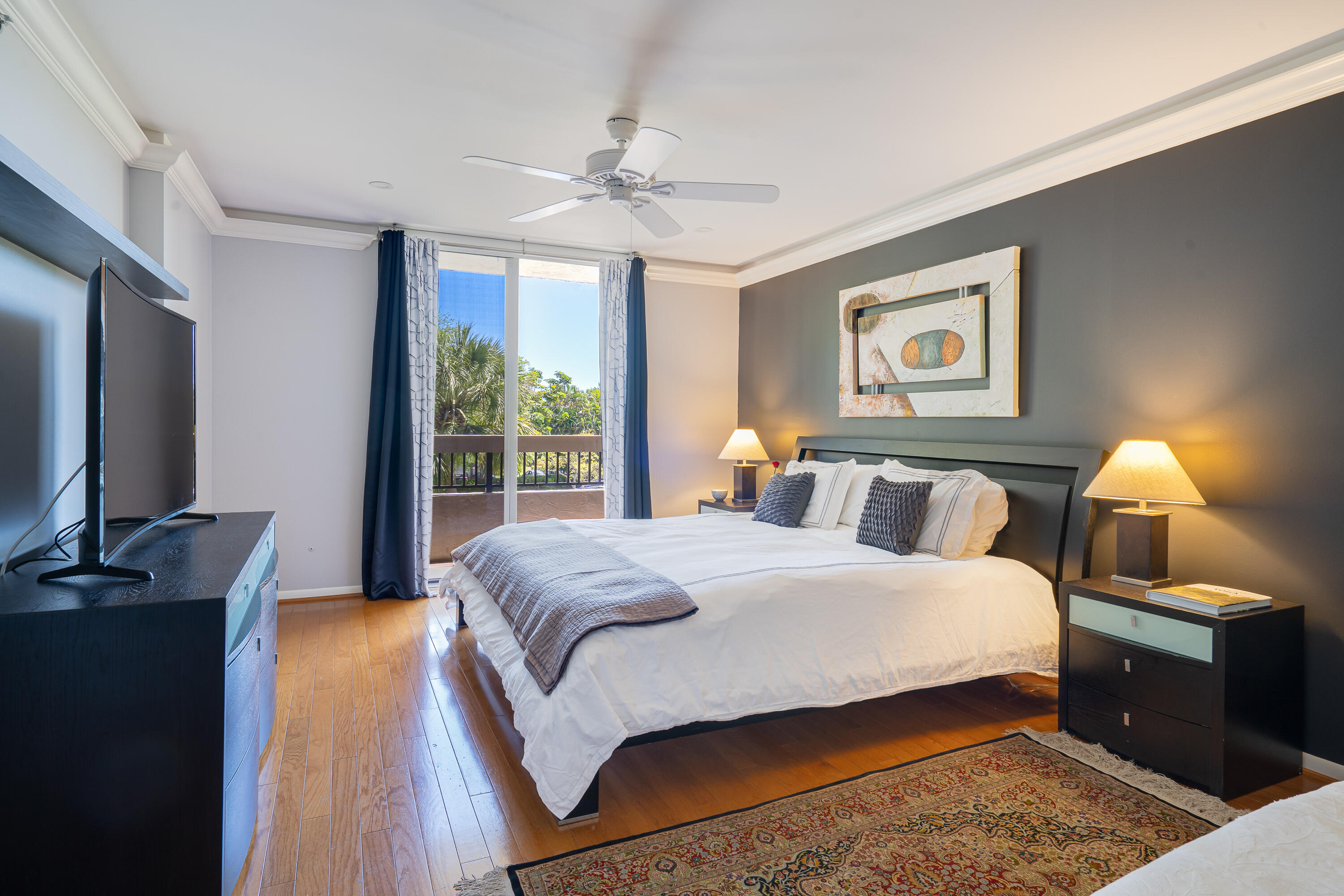 23200 Camino Del Mar, Unit 301 Boca Raton, FL 33433 - Photo 14 of 22 a bedroom with a bed and a flat screen tv