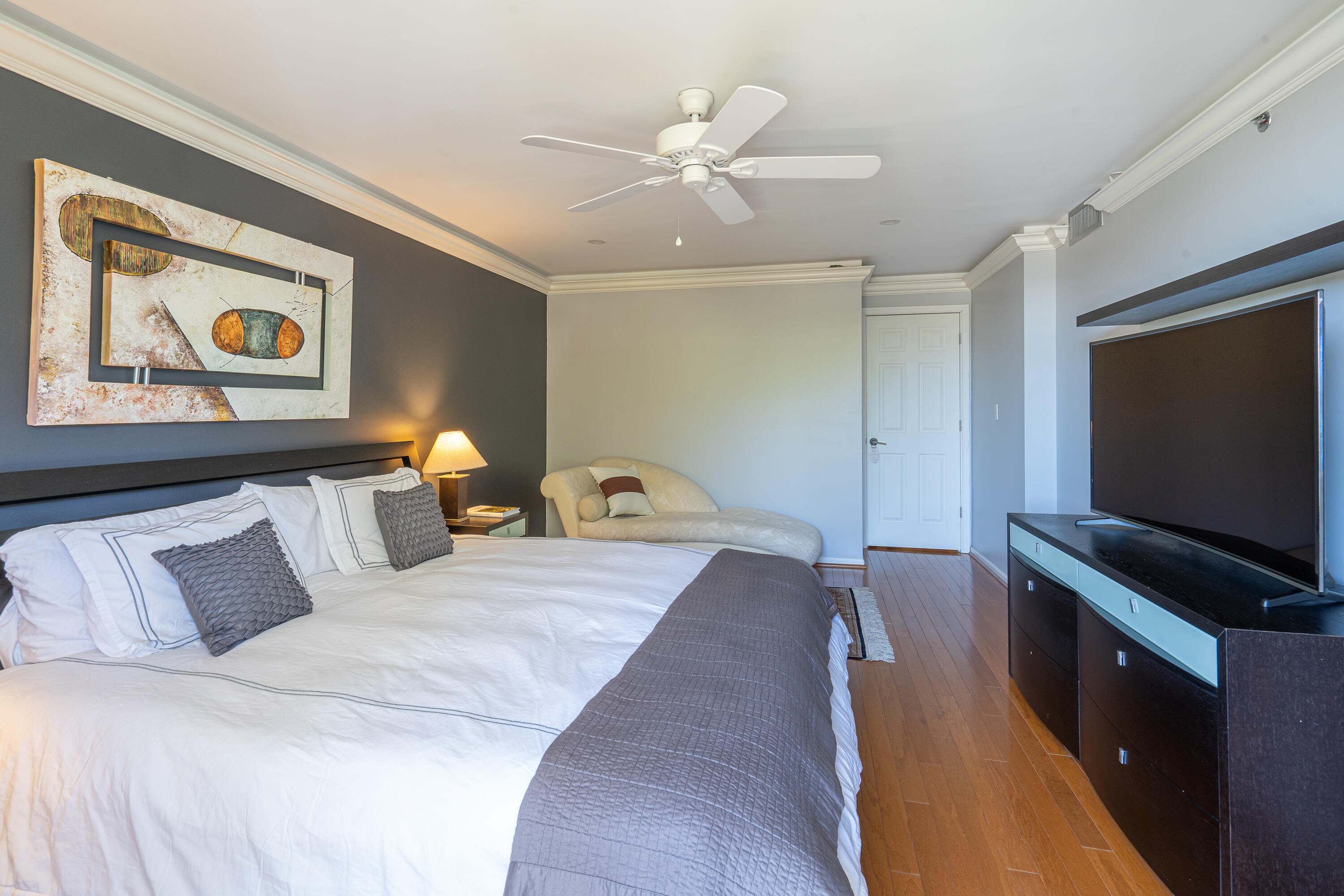 23200 Camino Del Mar, Unit 301 Boca Raton, FL 33433 - Photo 15 of 22 a bedroom with a bed and a flat screen tv