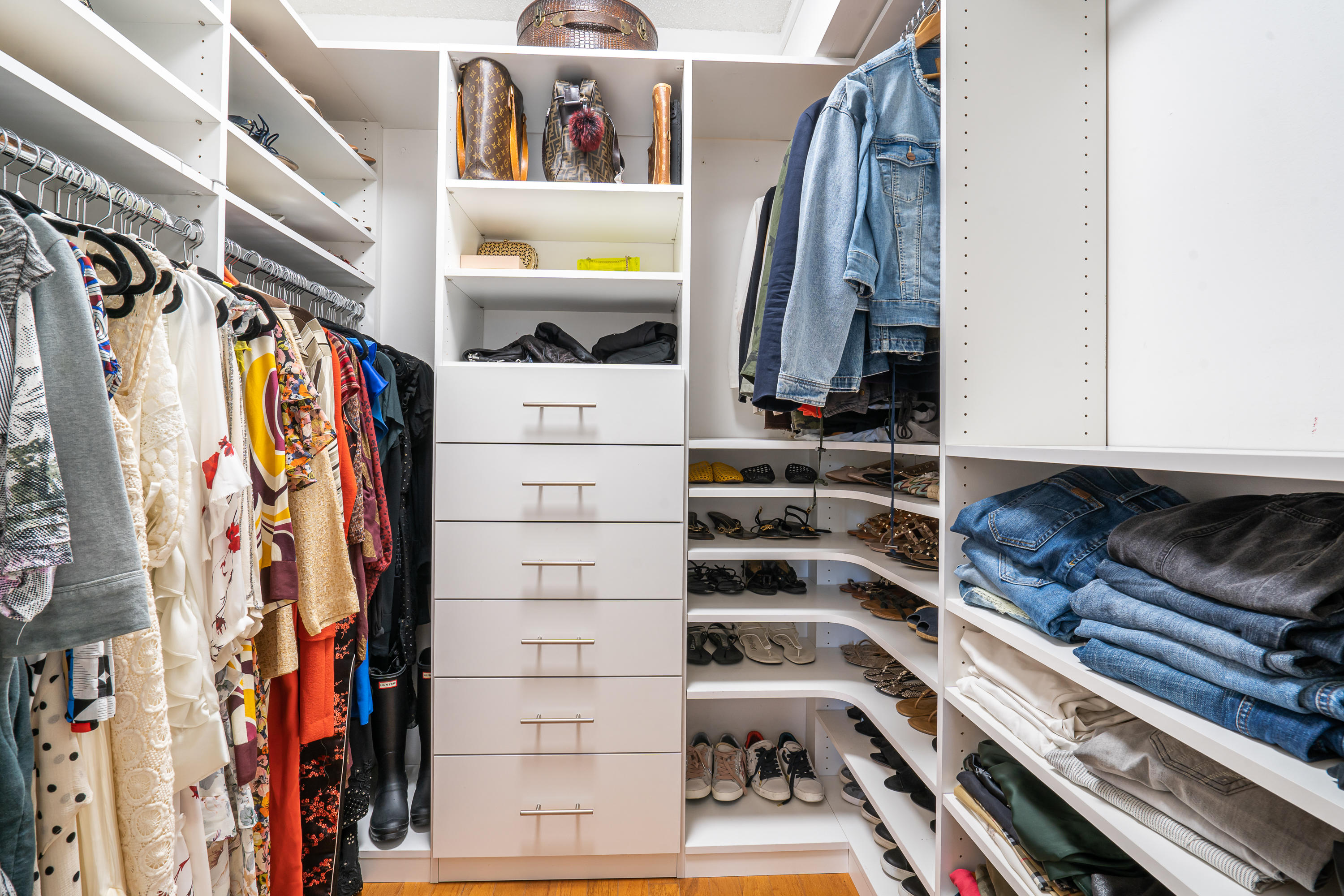 23200 Camino Del Mar, Unit 301 Boca Raton, FL 33433 - Photo 16 of 22 a view of walk in closet with clothes and shoes