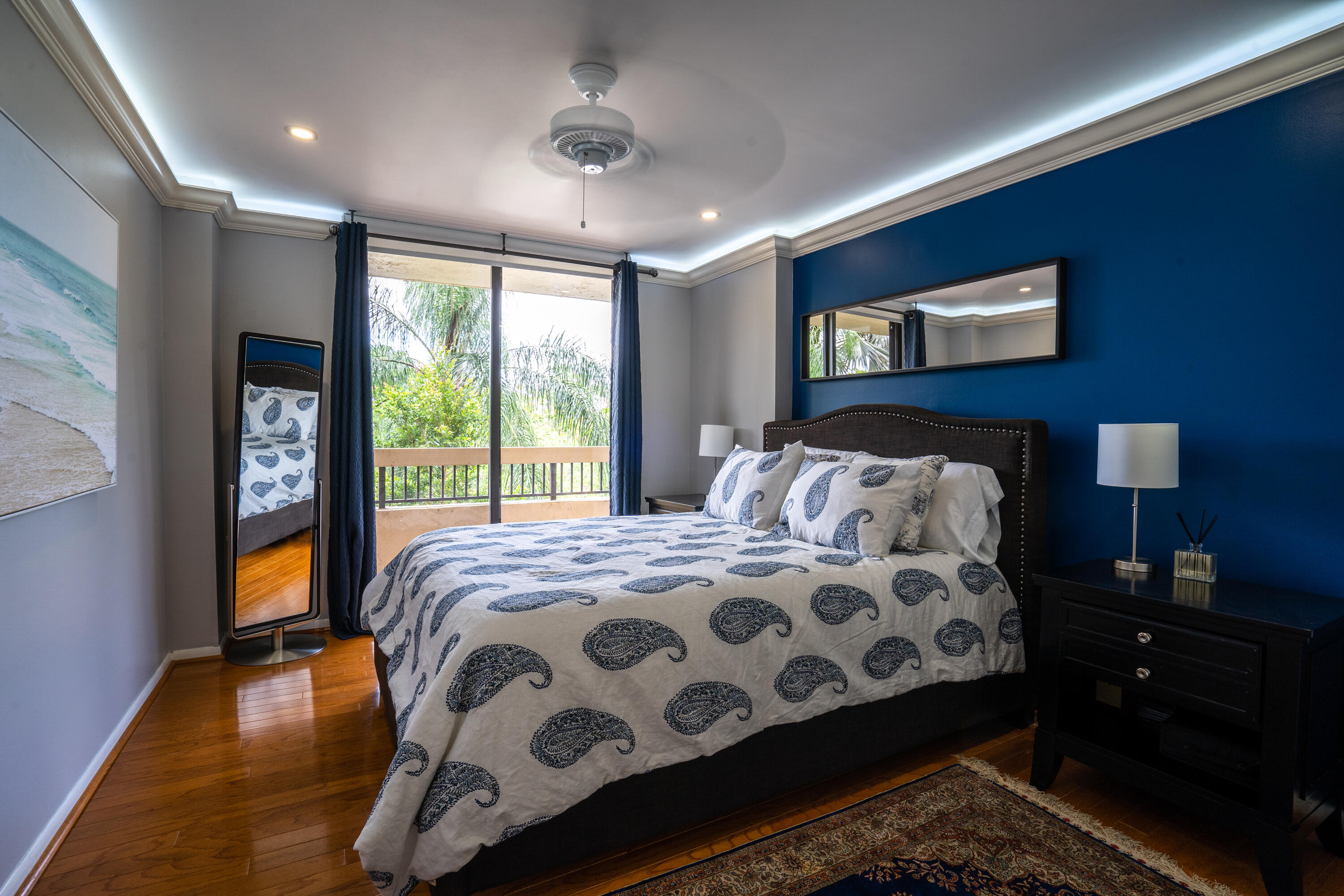 23200 Camino Del Mar, Unit 301 Boca Raton, FL 33433 - Photo 17 of 22 a bedroom with a bed and wooden floor