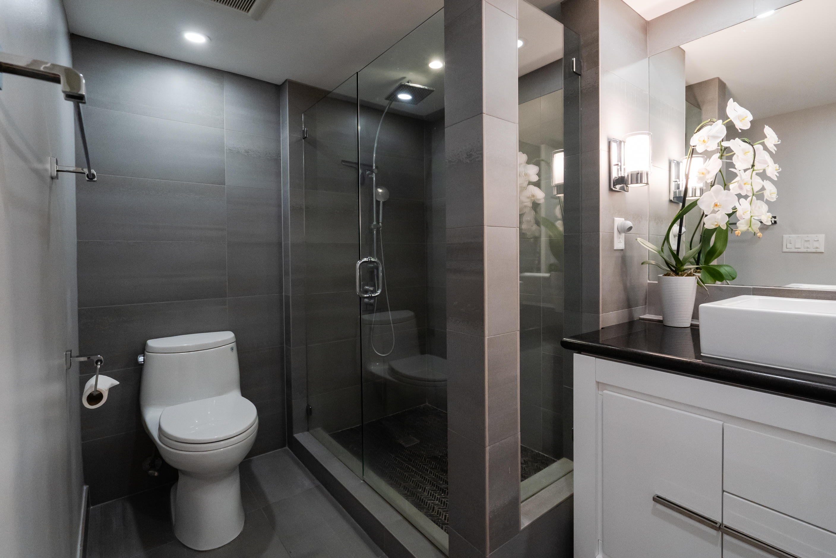 23200 Camino Del Mar, Unit 301 Boca Raton, FL 33433 - Photo 5 of 22 a bathroom with a toilet a sink and mirror