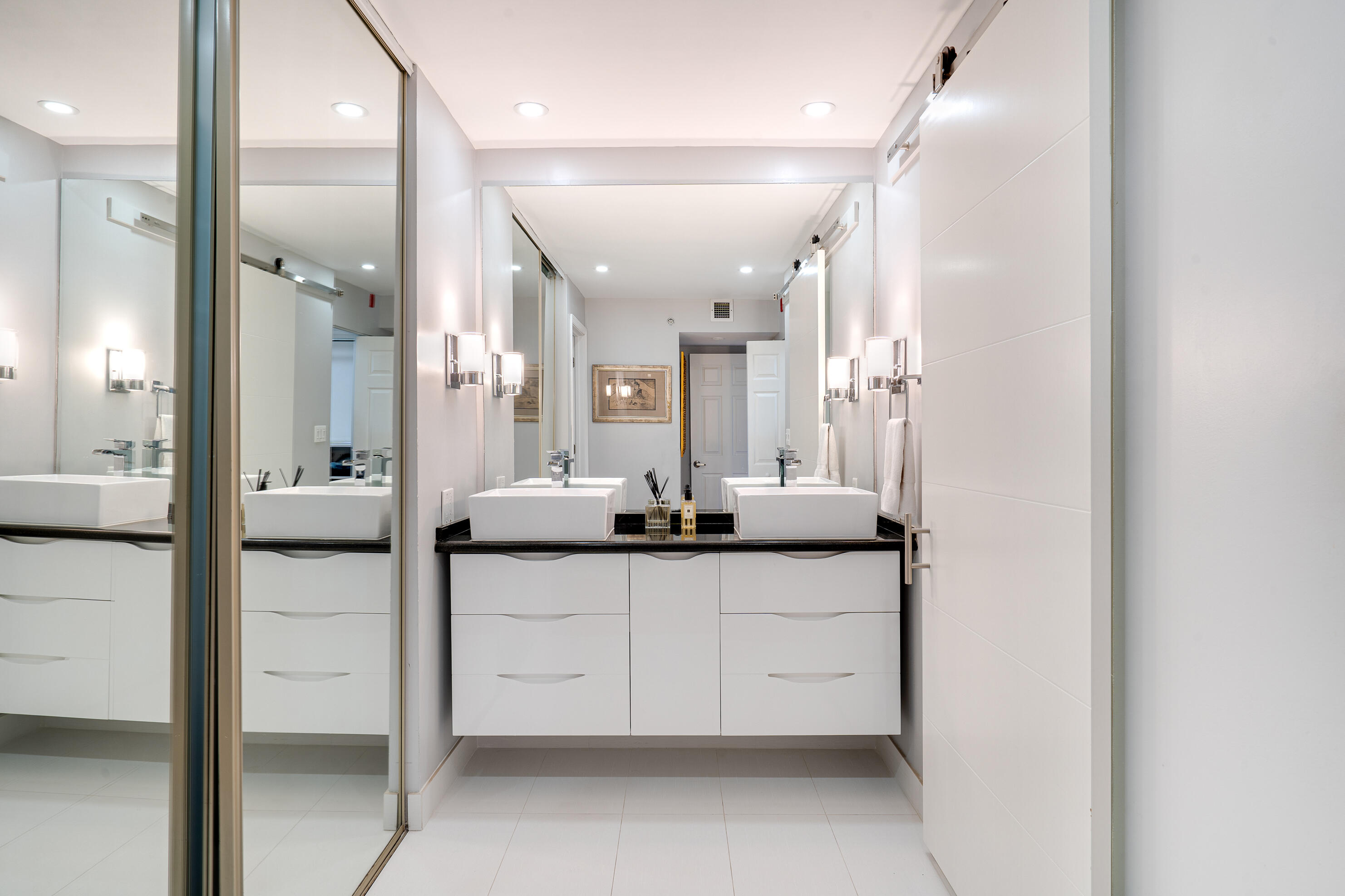 23200 Camino Del Mar, Unit 301 Boca Raton, FL 33433 - Photo 7 of 22 a bathroom with a granite countertop sink mirror and a