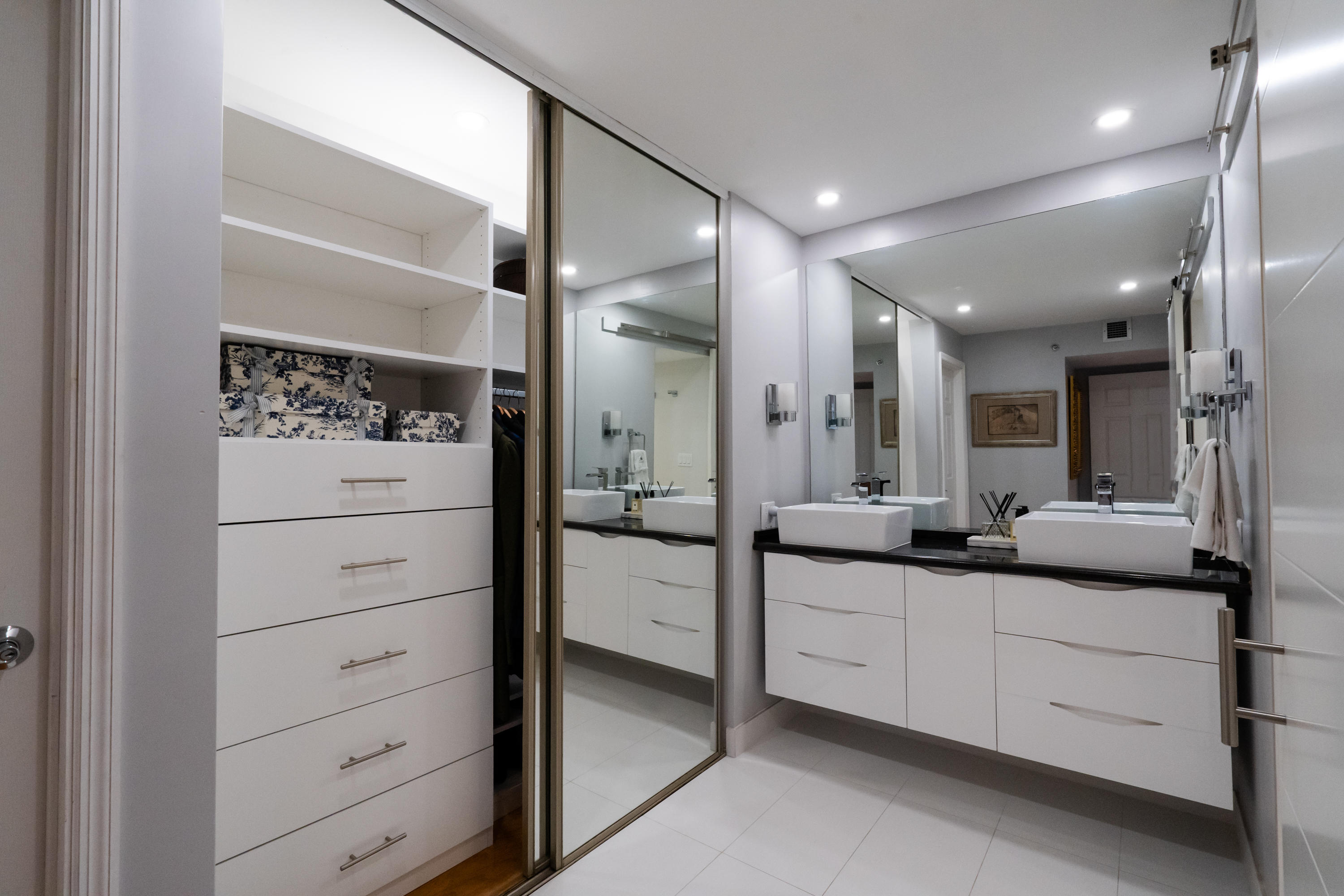 23200 Camino Del Mar, Unit 301 Boca Raton, FL 33433 - Photo 9 of 22 a bathroom with a double vanity sink mirror and shower