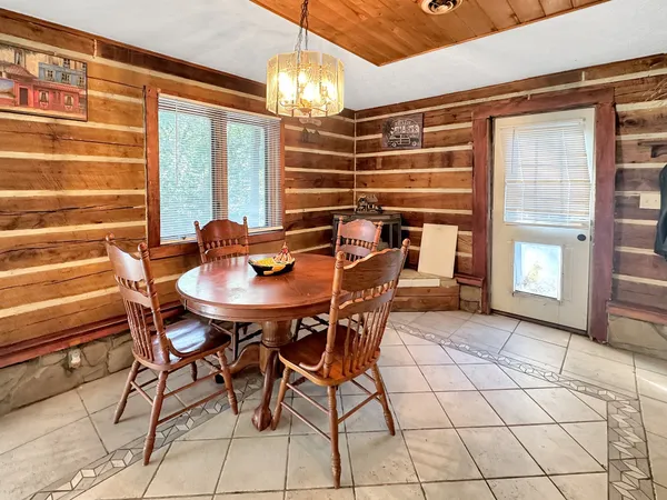 a view of a dining room with furniture and chandelier