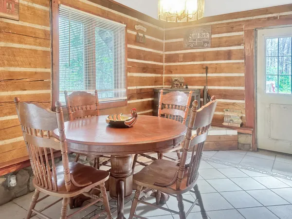a view of a dining room with furniture and windows