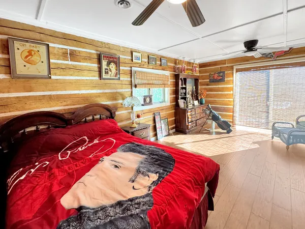 a bed sitting in a bedroom next to a window