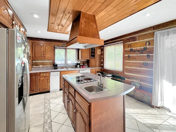 a kitchen with a sink a stove and cabinets