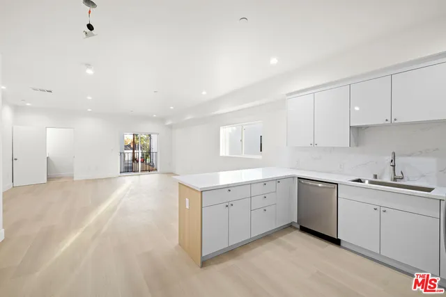 a spacious bathroom with a sink and a mirror