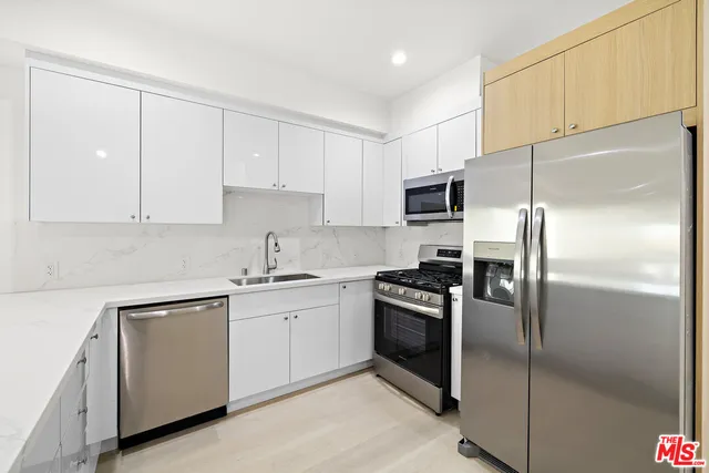 a kitchen with a refrigerator sink and microwave