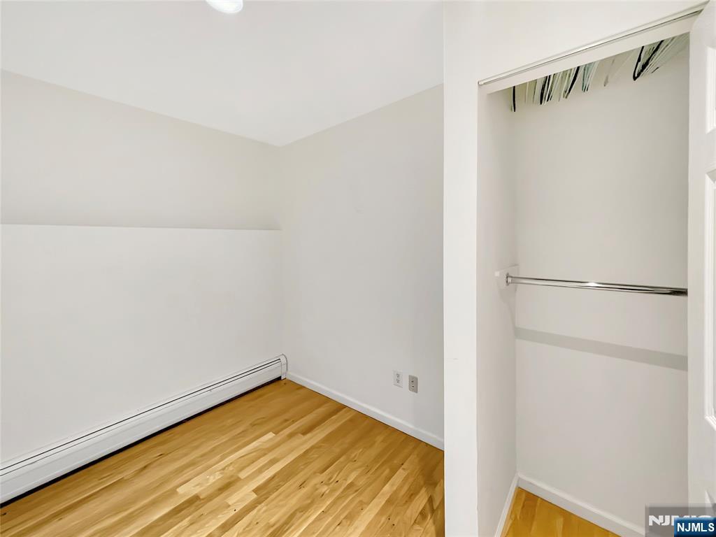 8913 Riverside Place, Unit 3 North Bergen, NJ 07047 - Photo 14 of 17 a view of a room with wooden floor