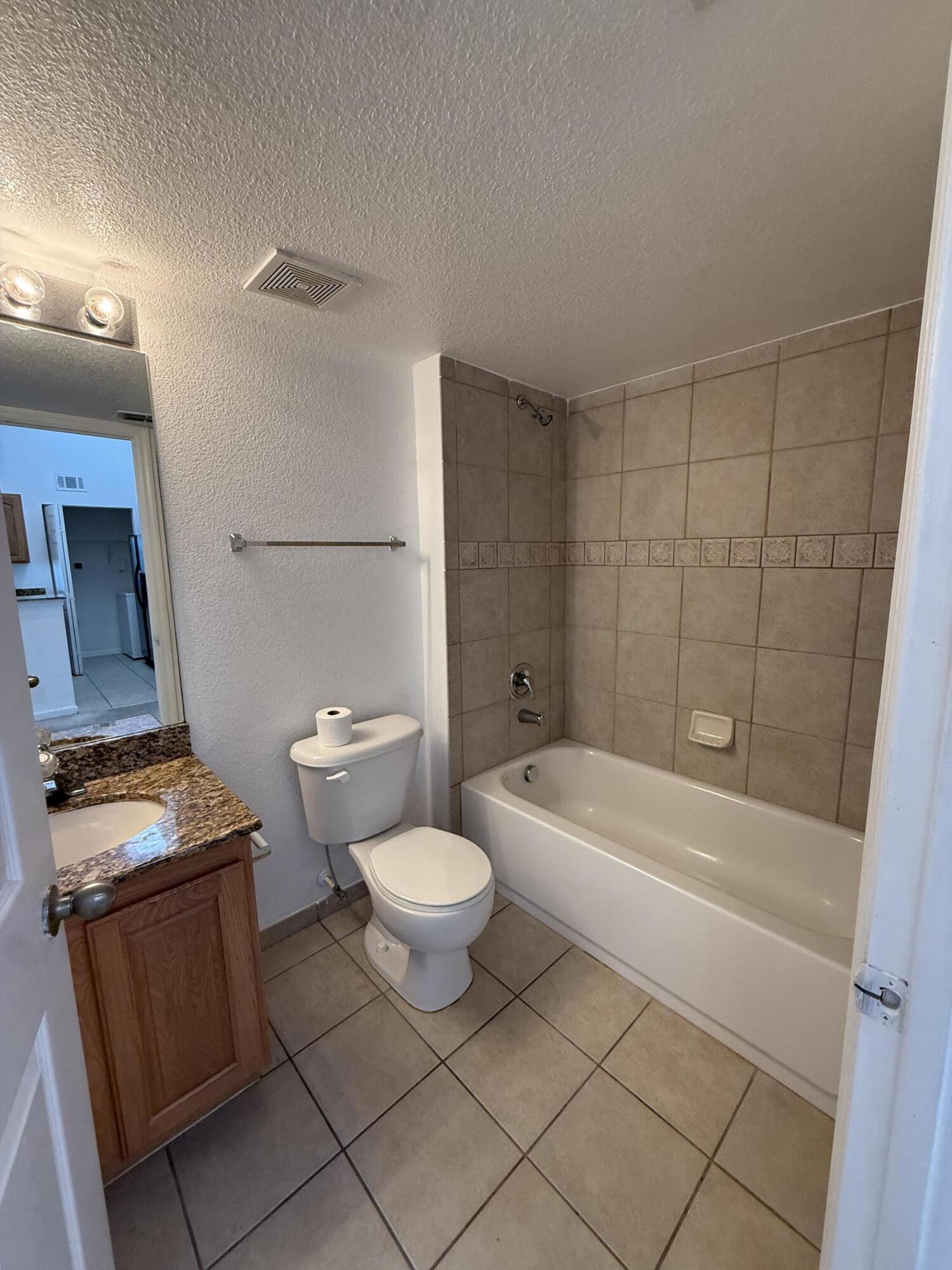 301 Southwest Palm Drive, Unit 305 Port St. Lucie, FL 34986 - Photo 13 of 17 a bathroom with a toilet a sink and bathtub