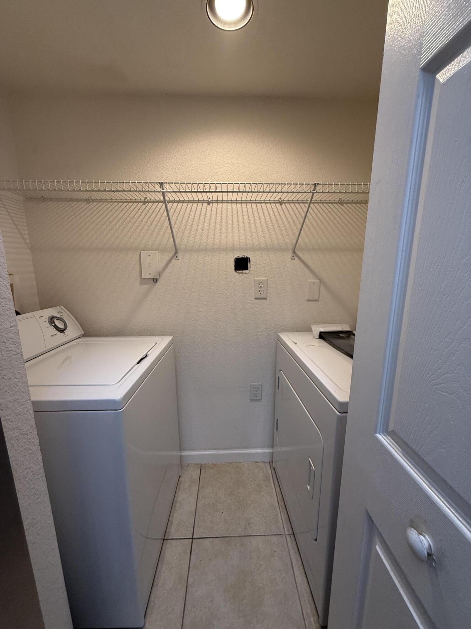 301 Southwest Palm Drive, Unit 305 Port St. Lucie, FL 34986 - Photo 14 of 17 a utility room with dryer and washer