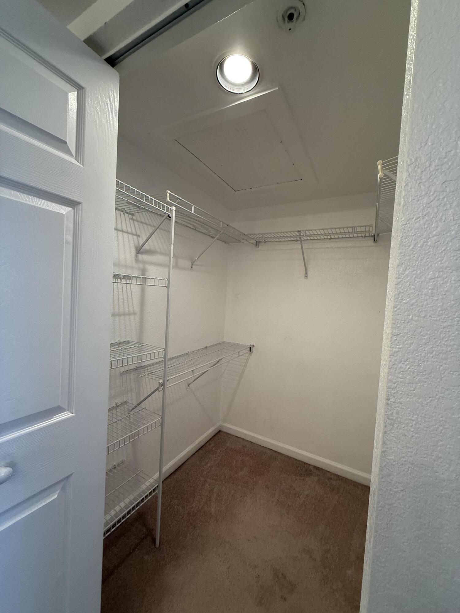 301 Southwest Palm Drive, Unit 305 Port St. Lucie, FL 34986 - Photo 7 of 17 a view of a room with racks on the wall