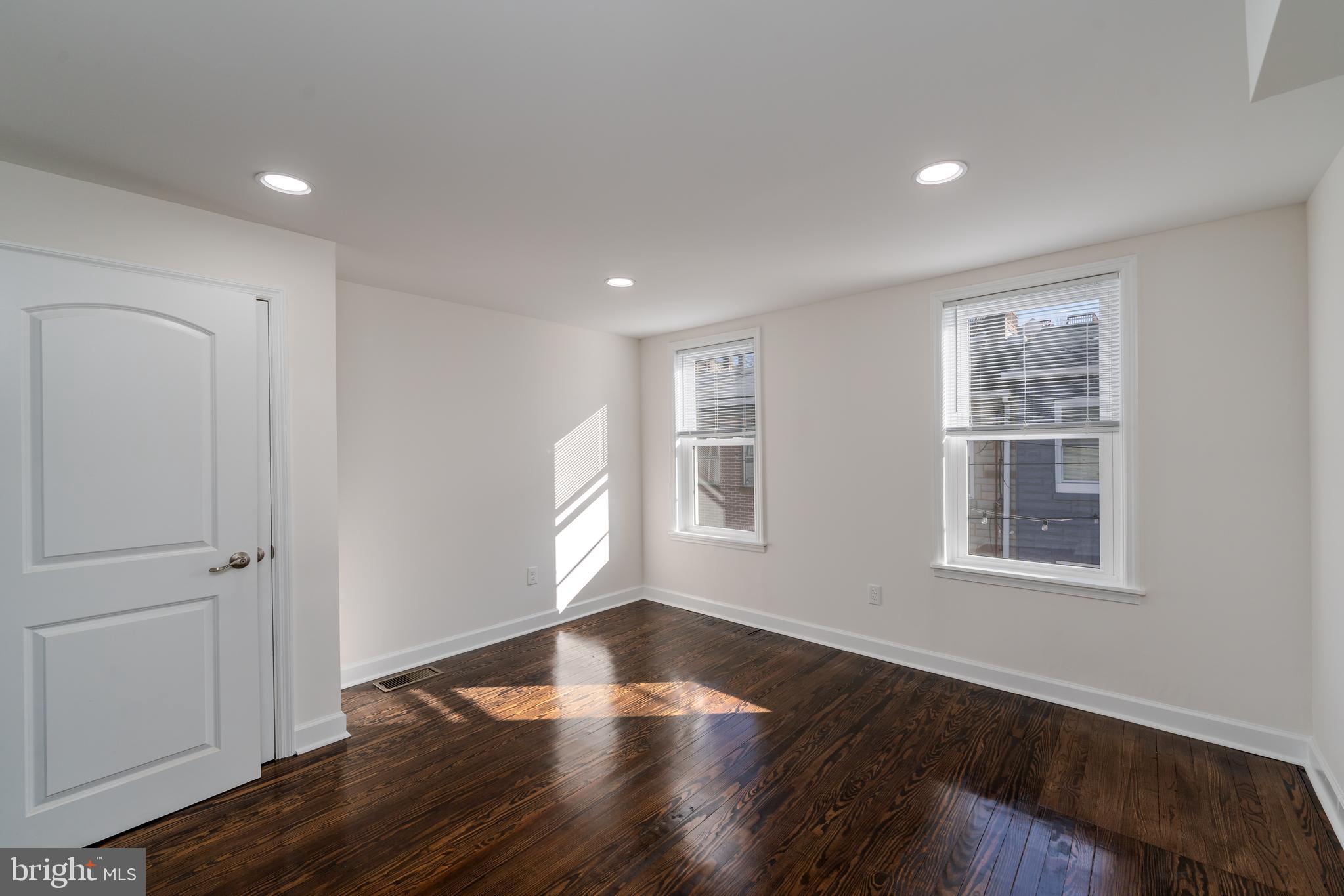 116 South Durham Street Baltimore, MD 21231 - Photo 12 of 28 an empty room with wooden floor and windows
