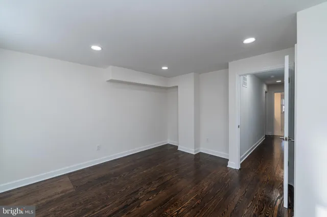 a view of hallway with wooden floor