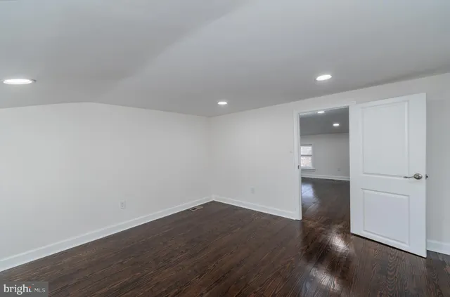 a view of a room with wooden floor and windows