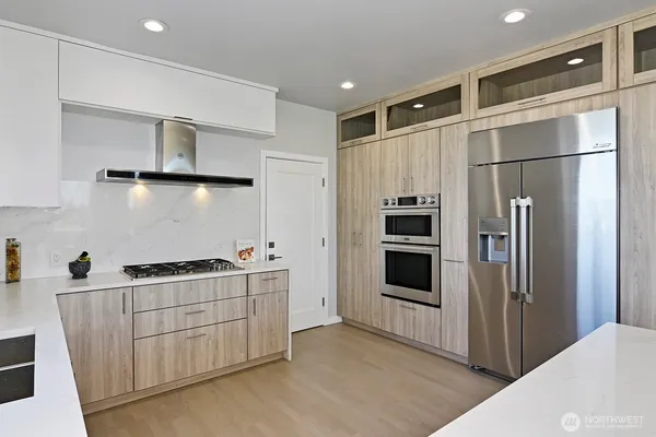 a kitchen with stainless steel appliances granite countertop a refrigerator and a sink