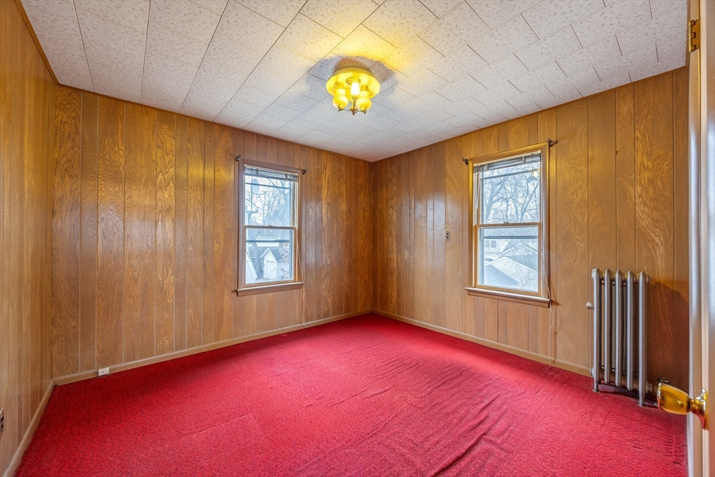97 Oklahoma Street Springfield, MA 01104 - Photo 16 of 25 a view of an empty room with window and wooden floor