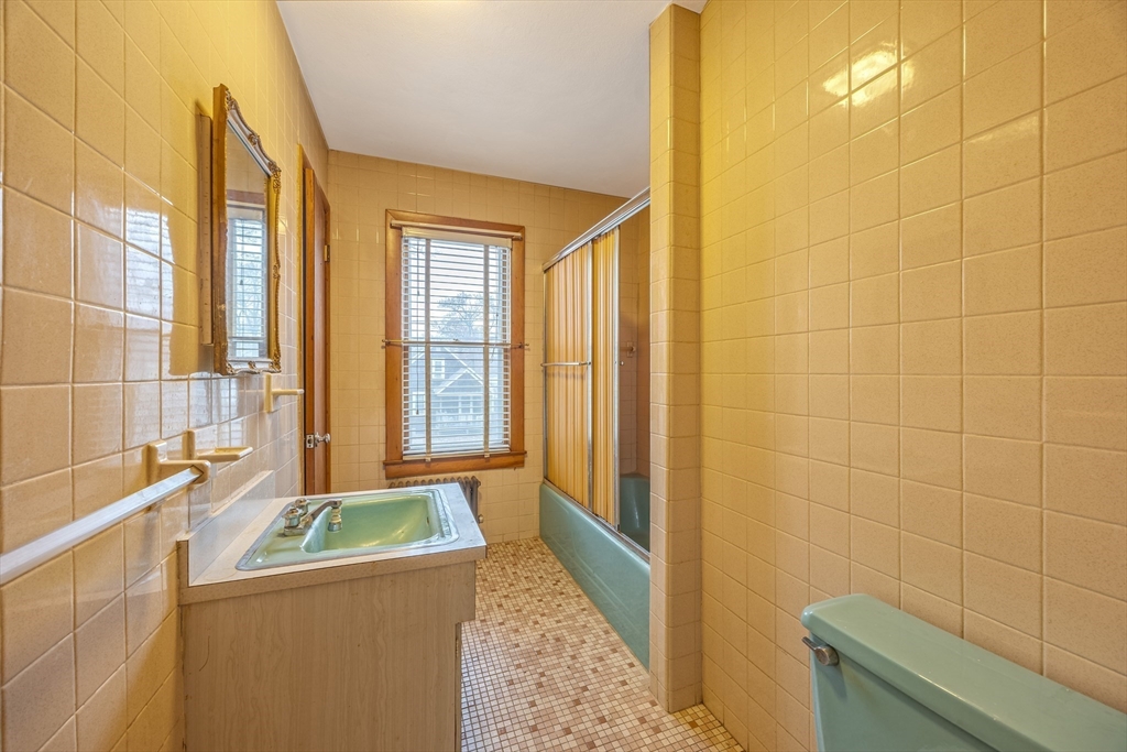 97 Oklahoma Street Springfield, MA 01104 - Photo 18 of 25 a bathroom with a granite countertop sink and a bathtub