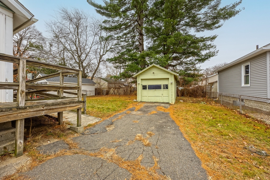 97 Oklahoma Street Springfield, MA 01104 - Photo 24 of 25 a front view of a house with a yard and trees