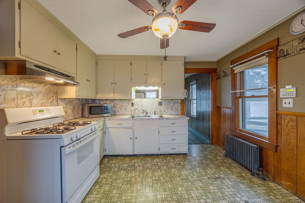 97 Oklahoma Street Springfield, MA 01104 - Photo 4 of 25 a kitchen with stainless steel appliances granite countertop a stove a sink and a refrigerator