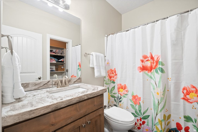 175 West 1000 North Mapleton, UT 84664 - Photo 22 of 42 Bathroom featuring a single vanity with wood cabinetry and a light-toned countertop, an integrated sink, and a chrome faucet